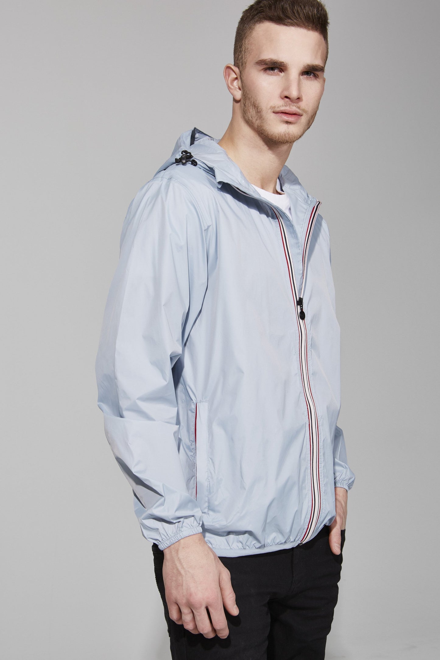 Full zip packable rain jacket and windbreaker in celestial blue