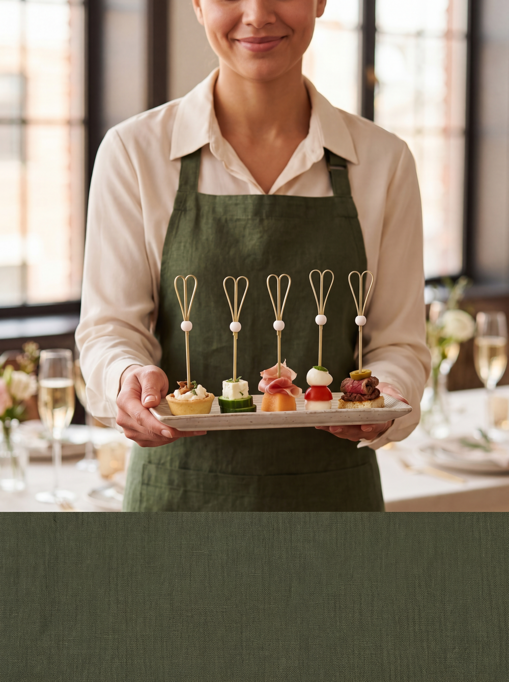 Server presenting canapés with white heart-loop bamboo picks